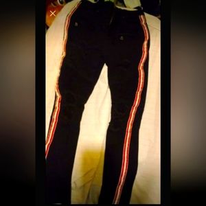 Rue 21 black skinny jean with red, black & white stripes down side,. size 30/32